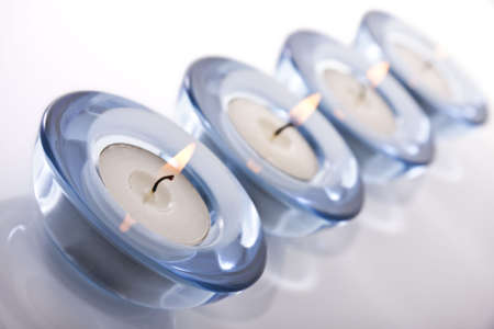 Four tealight candles on a white backgroundの写真素材
