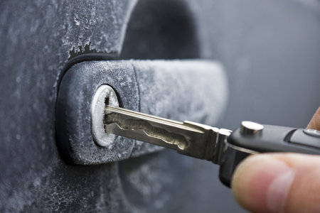 Unlocking a car door on a cold frozen winter morning