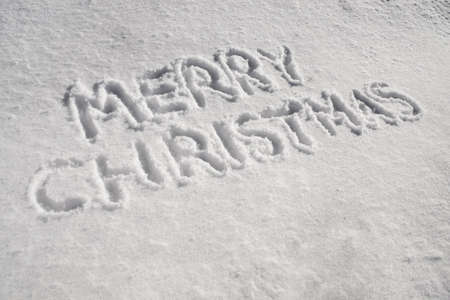 The words Merry Christmas written in the snowの写真素材