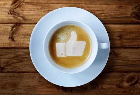 Thumbs up or like symbol in coffee frothの写真素材