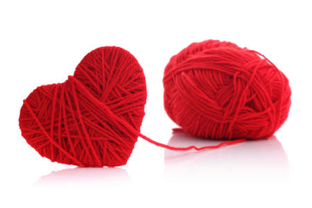 Red heart shape symbol made from wool isolated on white backgroundの写真素材