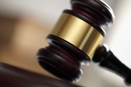 Judges hitting wooden gavel in courtroomの写真素材