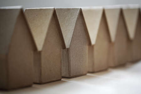 Cardboard houses in a row concept for community, neighborhood or real estate marketの写真素材