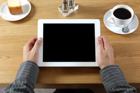 Digital tablet with blank screen in coffee shop cafe