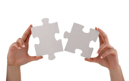 Puzzle pieces joining together concept for unity, teamwork or success with blank white face for messageの写真素材