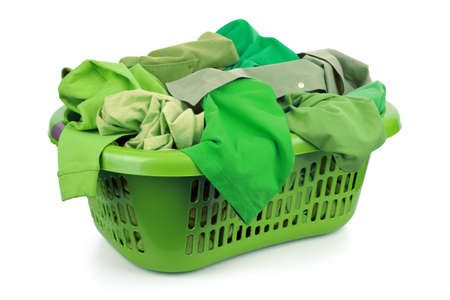 Green clothes in a laundry basket on white background concept for environmental conservation and eco friendly washingの写真素材