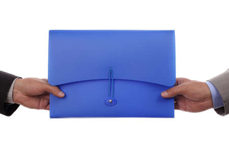 Partnership or teamwork concept two men handing over a document fileの写真素材