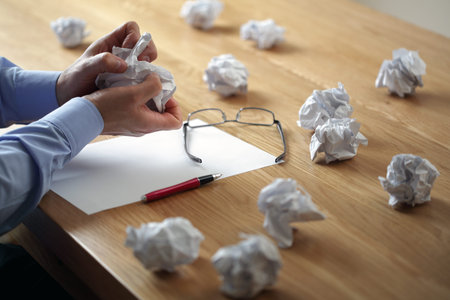Tearing up another crumpled paper ball for the pile