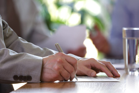Business meeting or lecture with businessman writing or signing contract