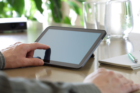Businessman finger pointing to the screen of a tablet-pc