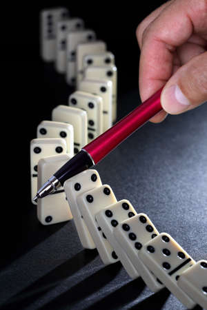 Stop the domino effect concept for solution to a problemの写真素材