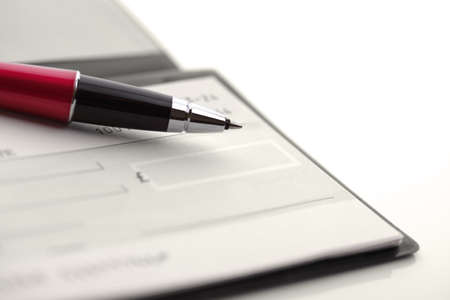 Blank cheque book with penの写真素材