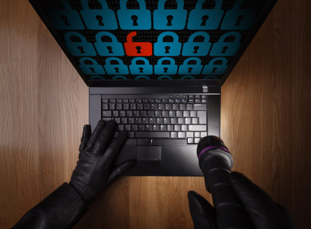 Computer hacker stealing data from a laptop concept for network security, identity theft and...