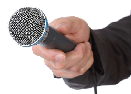 Mans hand holding a microphone conducting an interviewの写真素材