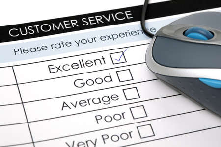 Tick placed in excellent checkbox on customer service satisfaction survey form with computer mouseの写真素材