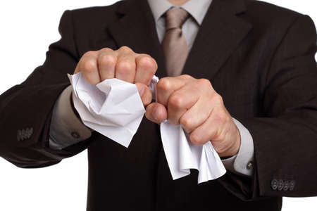 Angry businessman tearing up a document, contract or agreementの写真素材