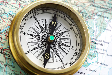 Old brass compass on map
