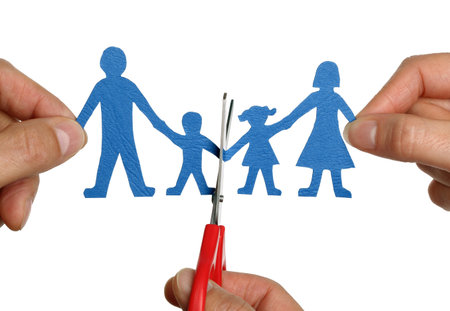 Man and womans hands cutting paper chain family concept for divorce and child custody battle