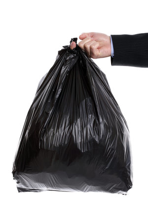 Businessman holding a black plastic trash bag in his hand
