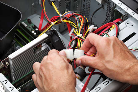 Computer engineer repairing a faulty pcの写真素材