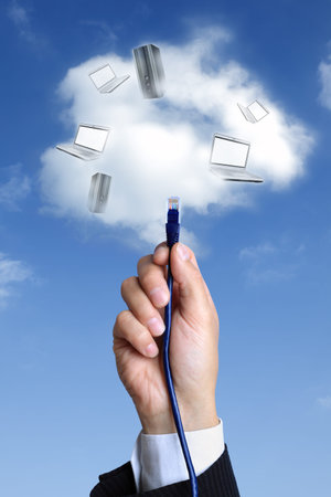 Concept for cloud computing -  busnessman hand connecting to the cloud with ethernet cable