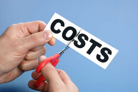 Scissors cutting the word costs concept for recession or credit crisisの写真素材