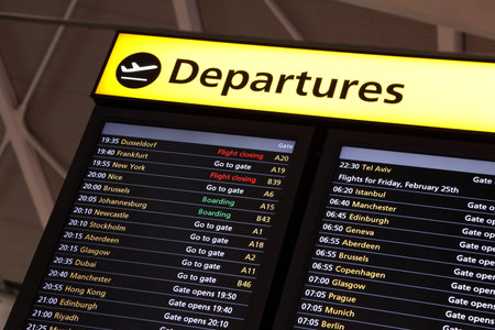 Airport flight information on a large screen international departure board