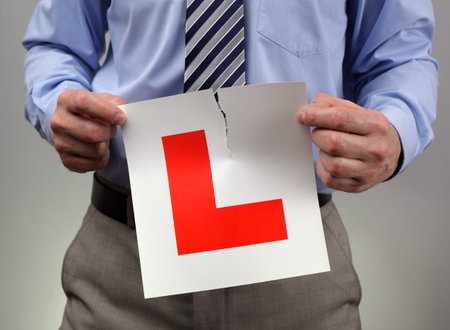 Businessman tearing up L plate
