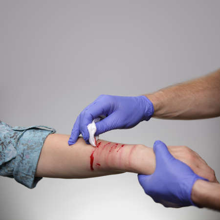 Self harm victim being treated by paramedic or doctorの写真素材