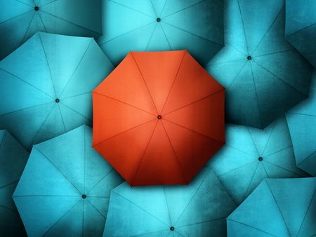 Red umbrella standing out from the crowd of blue brollysの写真素材
