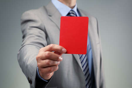 Showing the red card concept for bad business practice, exclusion or criminal activityの写真素材
