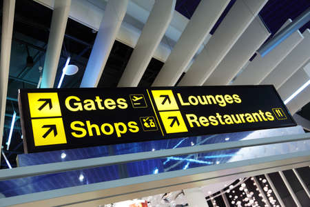 Airport flight gate, shop, restaurant and lounge direction information signの写真素材