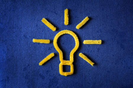 Inspiration concept yellow pipe cleaner light bulb metaphor for good ideaの写真素材