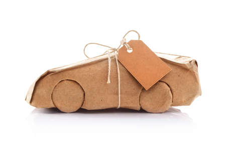 New car wrapped in recycled brown wrapping paperの写真素材