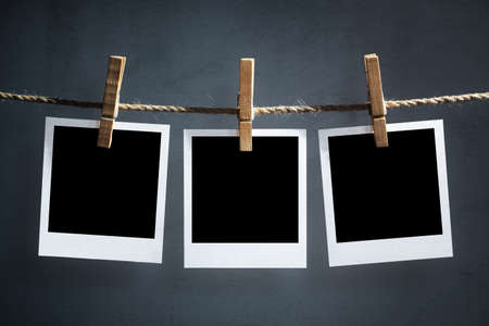 Blank instant print transfer photographs hanging on a clotheslineの写真素材