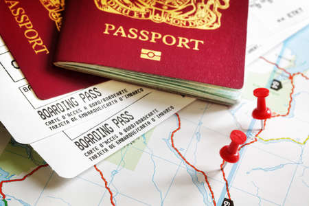 Boarding pass and passport on map with thumbtack concept for travel and vacationsの写真素材