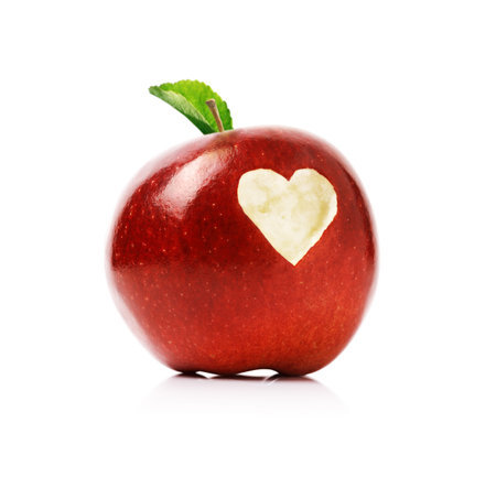 Red delicious apple with a love heart shape bitten into the fleshの写真素材