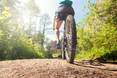 Mountain biker in action on a forest trail concept for healthy lifestyle, excercise and extreme sportsの写真素材