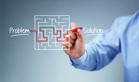Business strategy businessman planning and finding a solution through a drawing of a labyrinth mazeの写真素材
