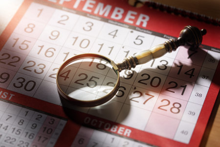 Calendar planning magnifying glass resting on an important date concept fpr deadline business...