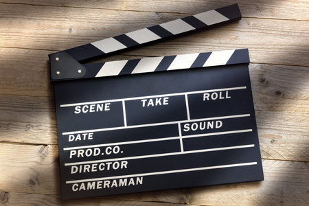 Film slate or movie clapper board on wood backgroundの写真素材