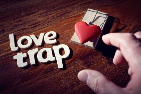 Mousetrap with heart concept for love trap, affair, temptation, heartbreak and flirting