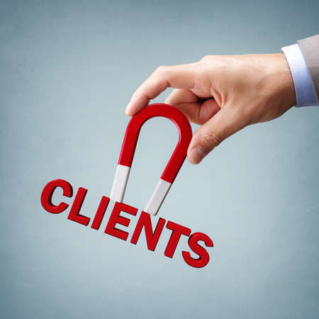 Magnet attracting new business clients and customersの写真素材