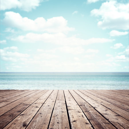 Summer vacation background wooden plank boardwalk with sea and blue sky copy space