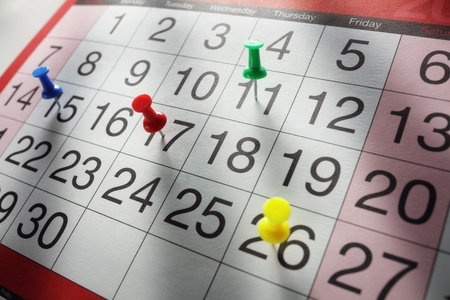 Thumbtack in calendar concept for busy, appointment and meeting reminderの写真素材