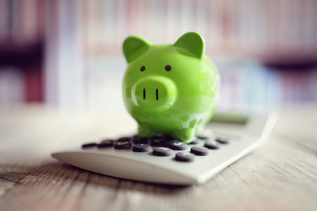 Piggy bank on calculator concept for saving, accounting, banking and business accountの写真素材