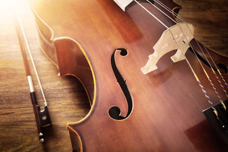Cello on wood background with copy space for music conceptの写真素材