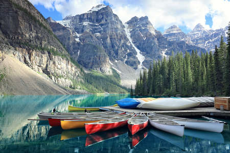 Canoes on a jetty at Moraine lake, Banff national park in the Rocky Mountains, Alberta, Canadaの写真素材