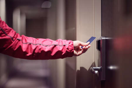 Opening a hotel door with keyless entry cardの写真素材