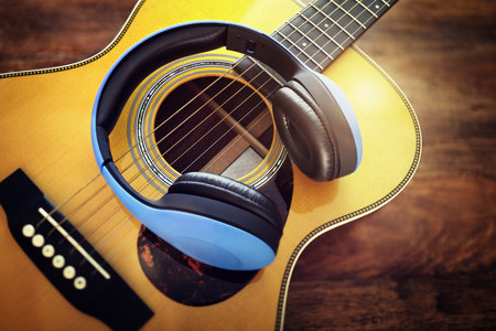 Guitar and headphones concept for listening to music or recording studio equipment